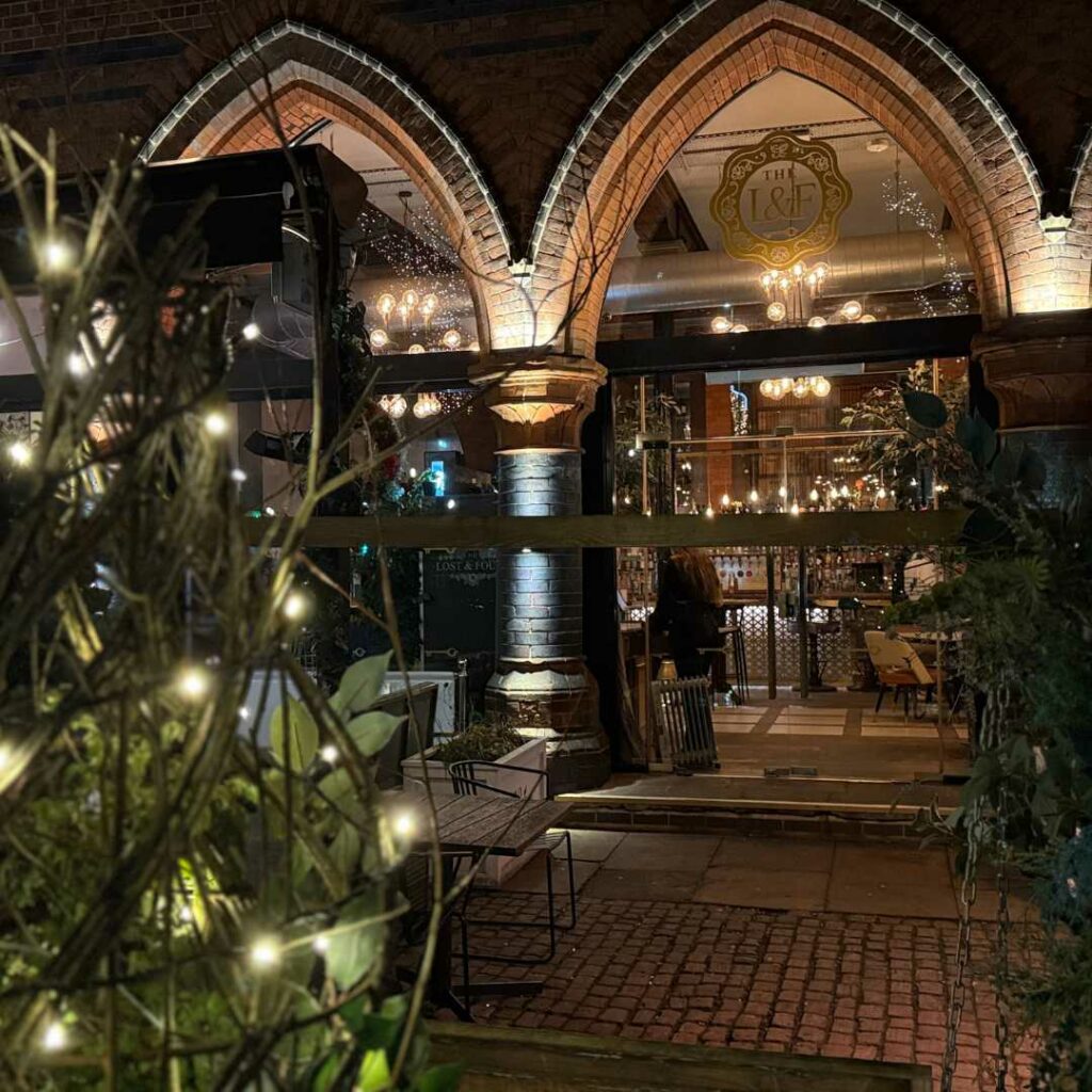 a building with a brick walkway and a brick walkway with lights