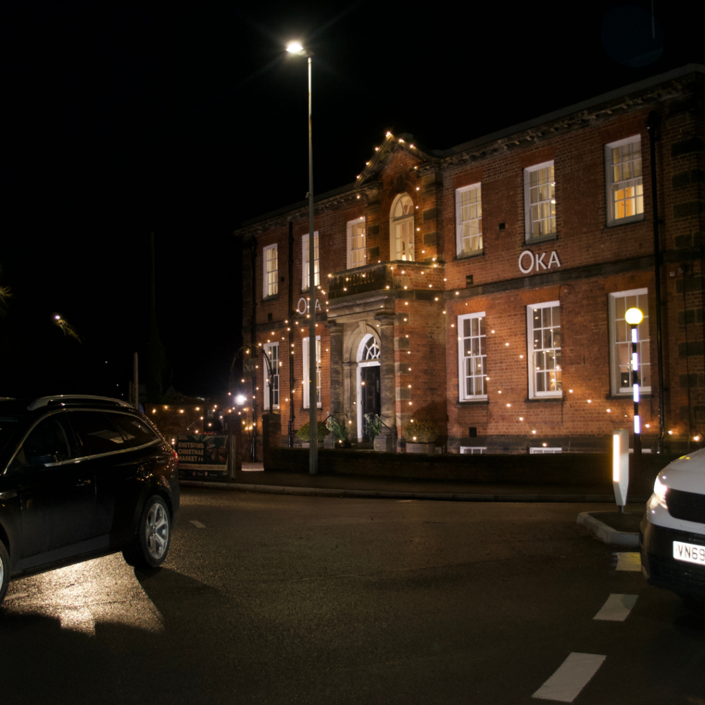 a building with a brick walkway and a brick walkway with lights