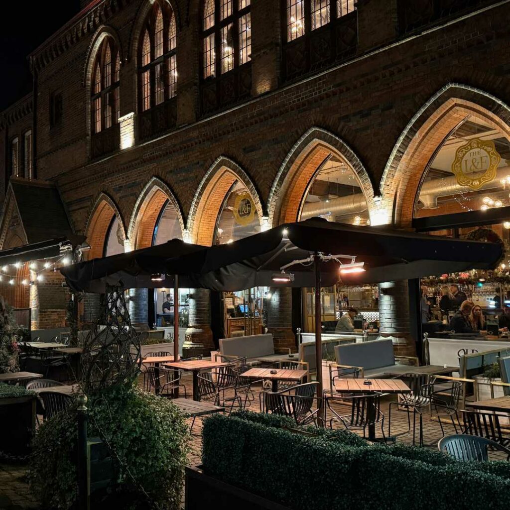 a building with a brick walkway and a brick walkway with lights