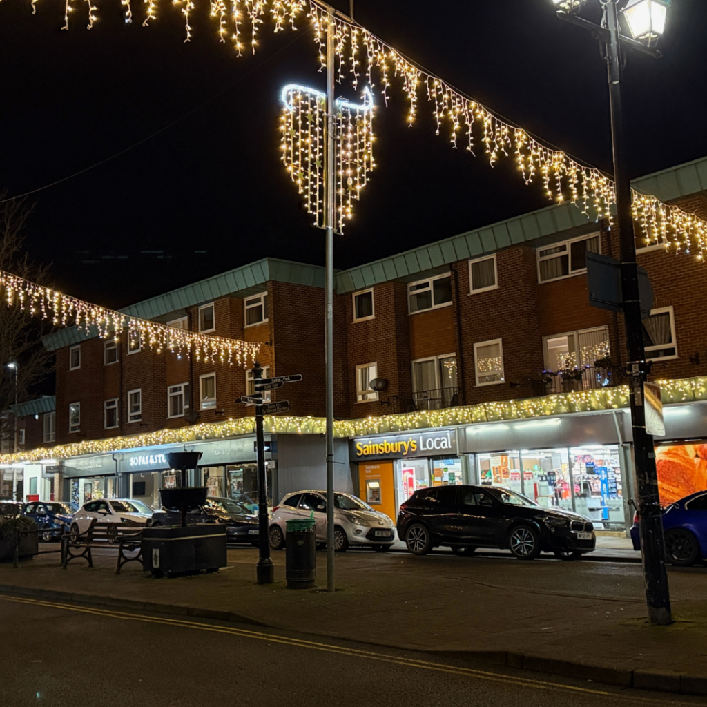 a building with a brick walkway and a brick walkway with lights