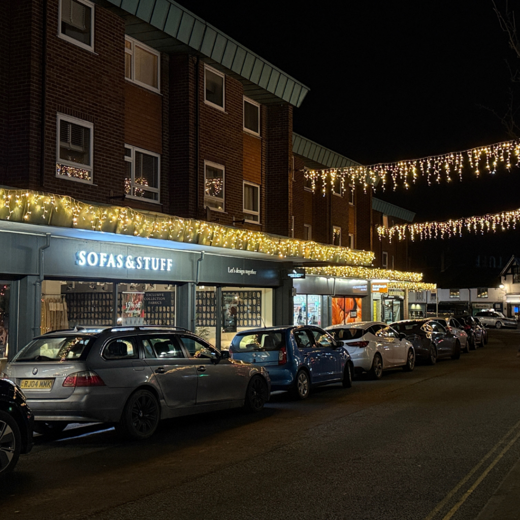 a building with a brick walkway and a brick walkway with lights